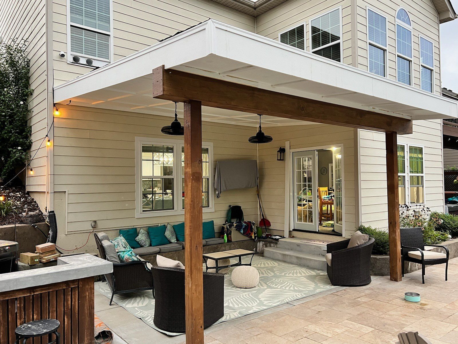 Covered patio with stone flooring and lounge seating