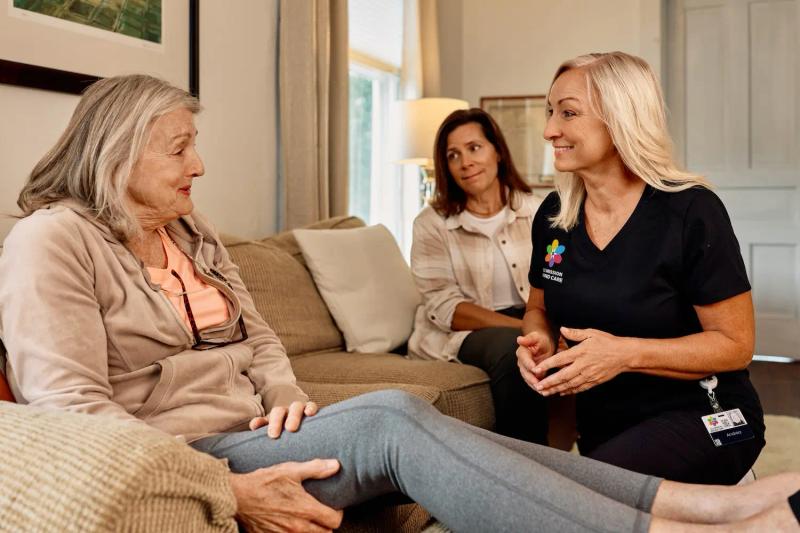A value-based wound care nurse talks to a patient in her home.