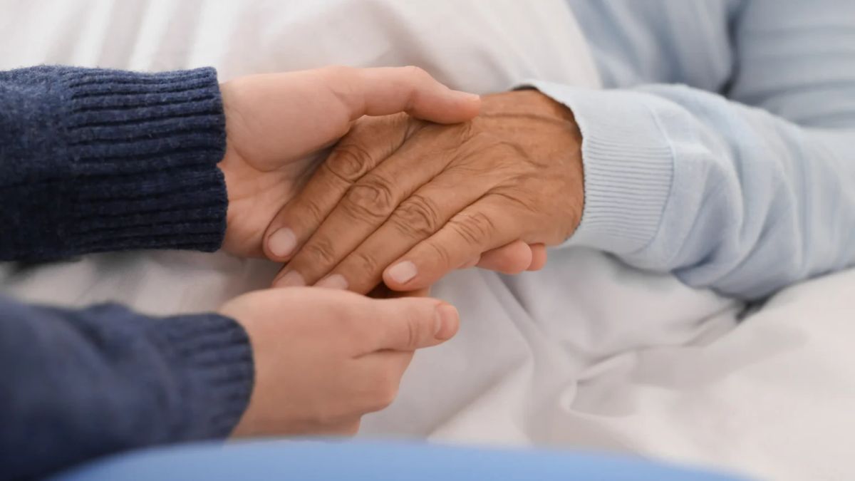 Family holding hands during end-of-life care in Melbourne