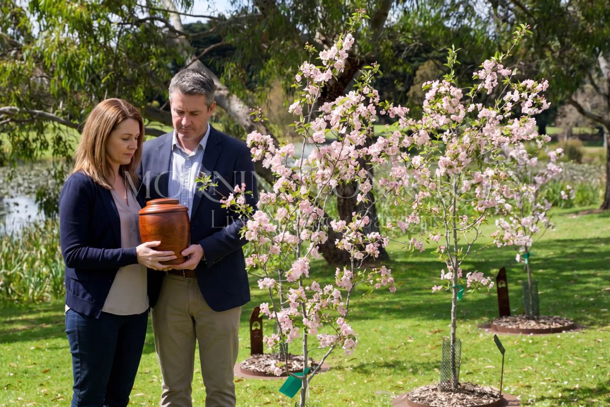 Family holding ashes at a celebration of life ceremony