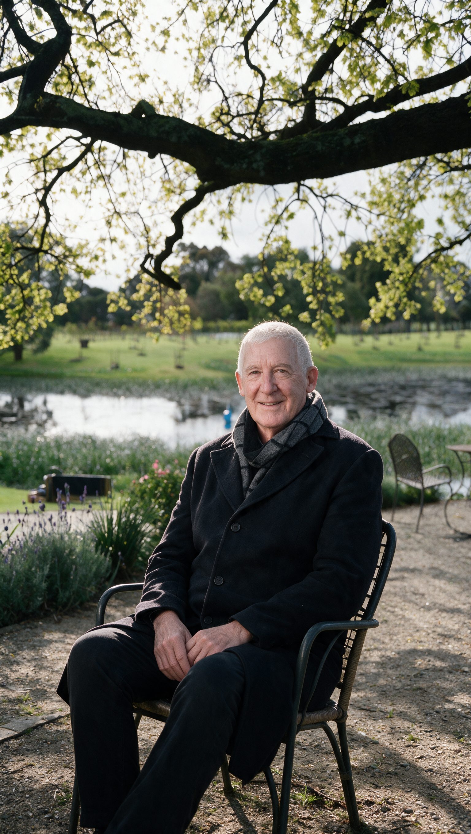 Michael sitting under a tree by the lake at mornington green