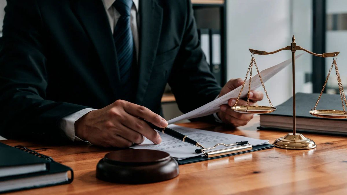 Lawyer reviewing legal documents beside scales of justice, representing Australian cremation ash laws