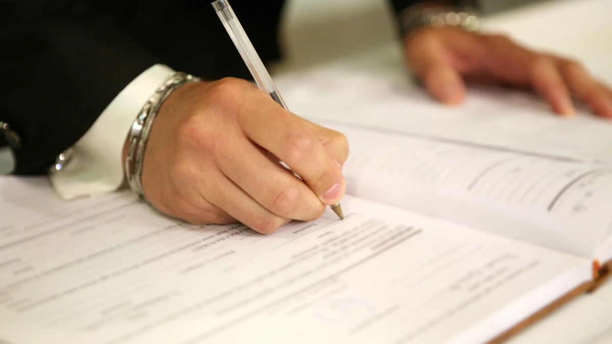 Person completing notification paperwork for organisations after a parent dies in Australia