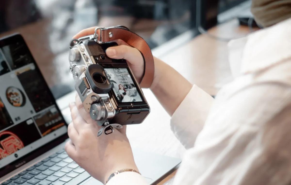 Person scanning old family photos to create a digital memorial archive