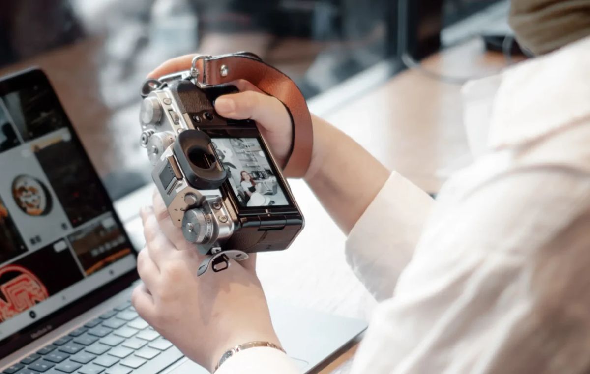 Person scanning old family photos to create a digital memorial archive
