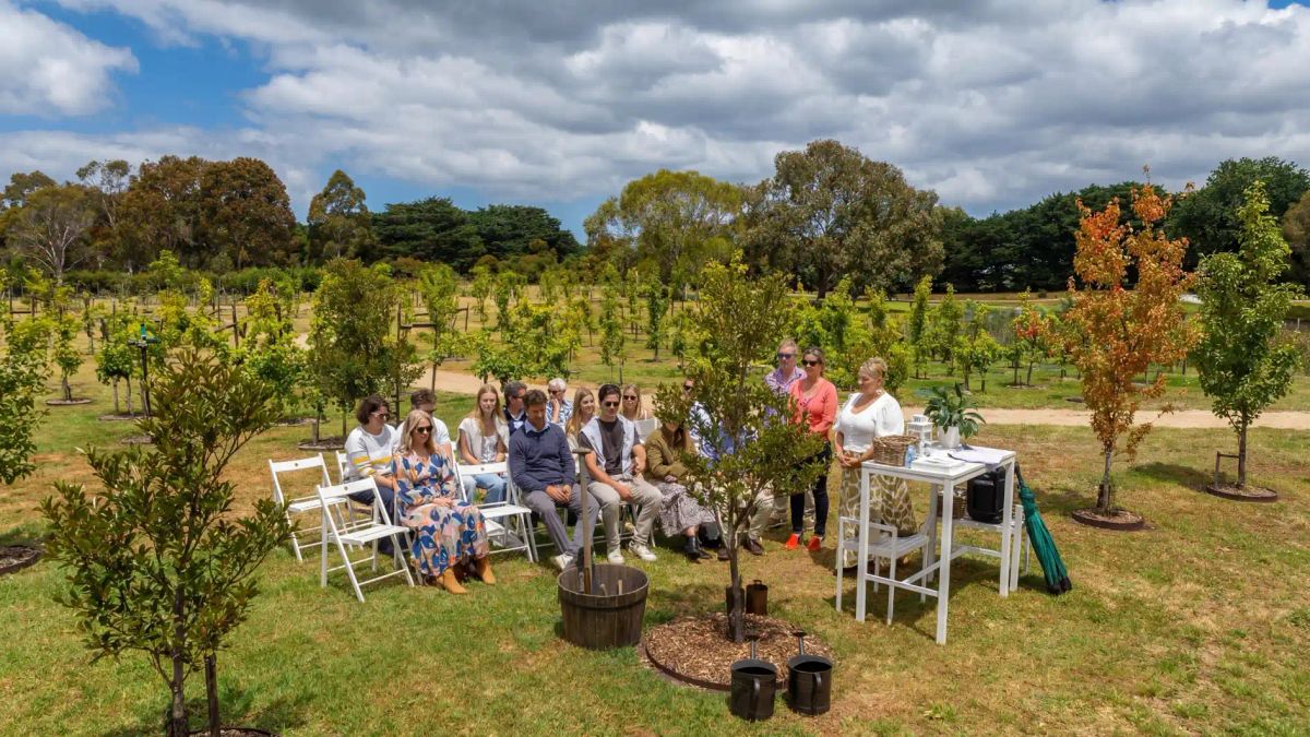 Family gathering at a living memorial tree dedication ceremony at Mornington Green Living Legacy Gardens