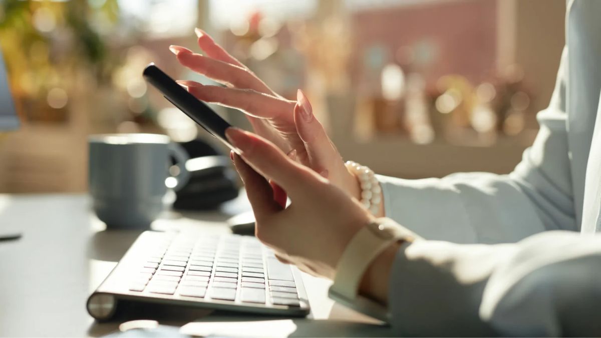 Woman scrolling a Facebook memorial page for a late parent