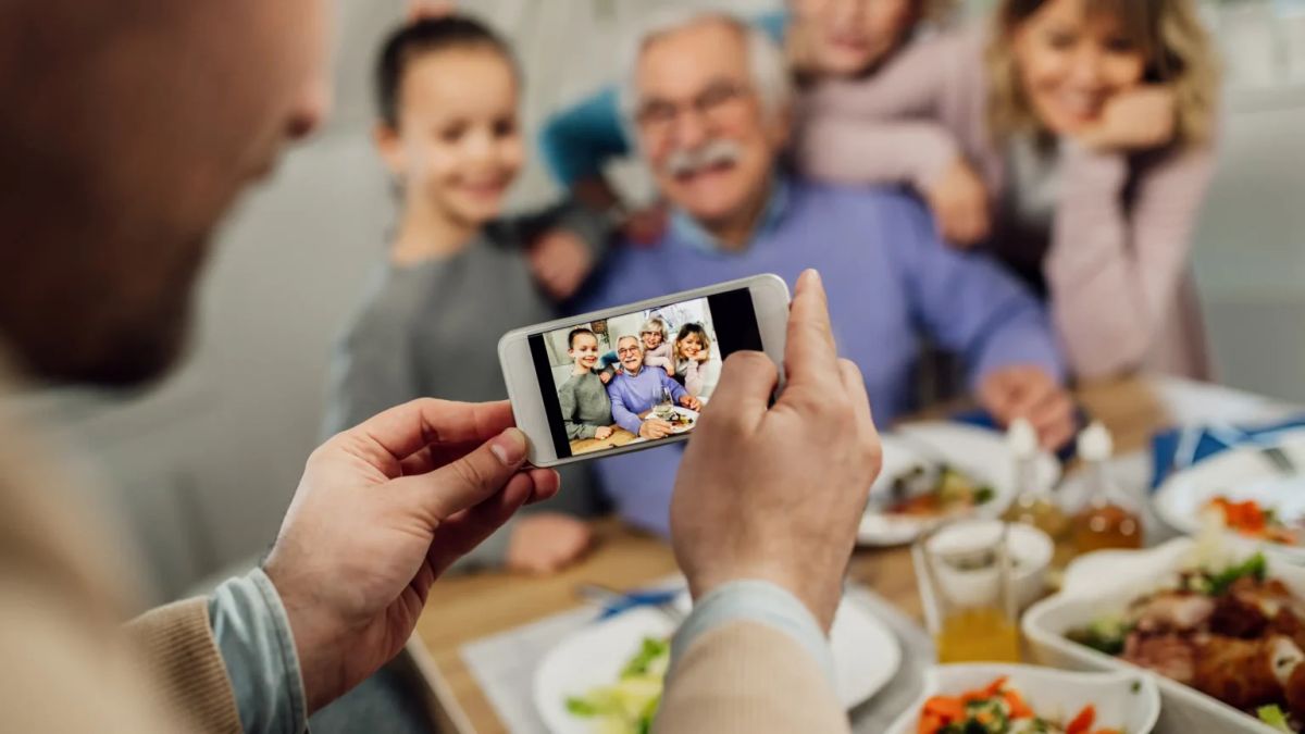 Family viewing a photo of their late father during a birthday gathering
