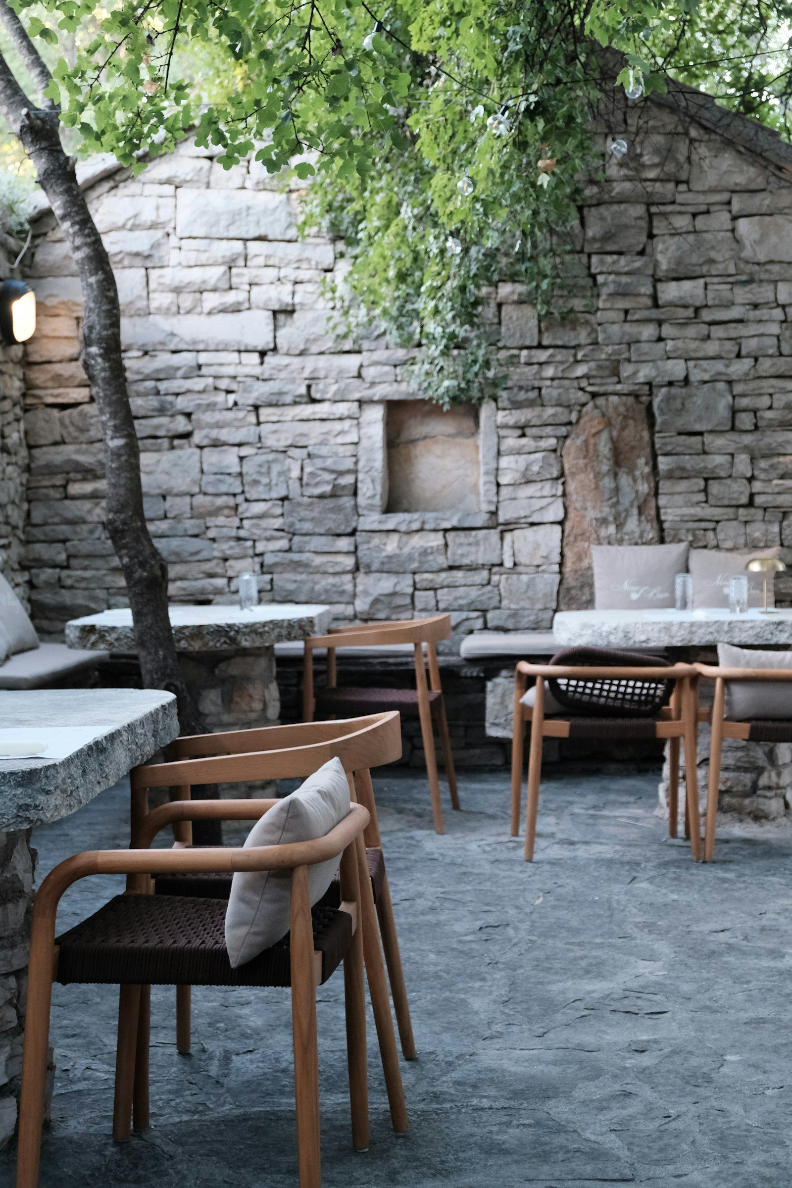 Stone courtyard with cushioned chairs