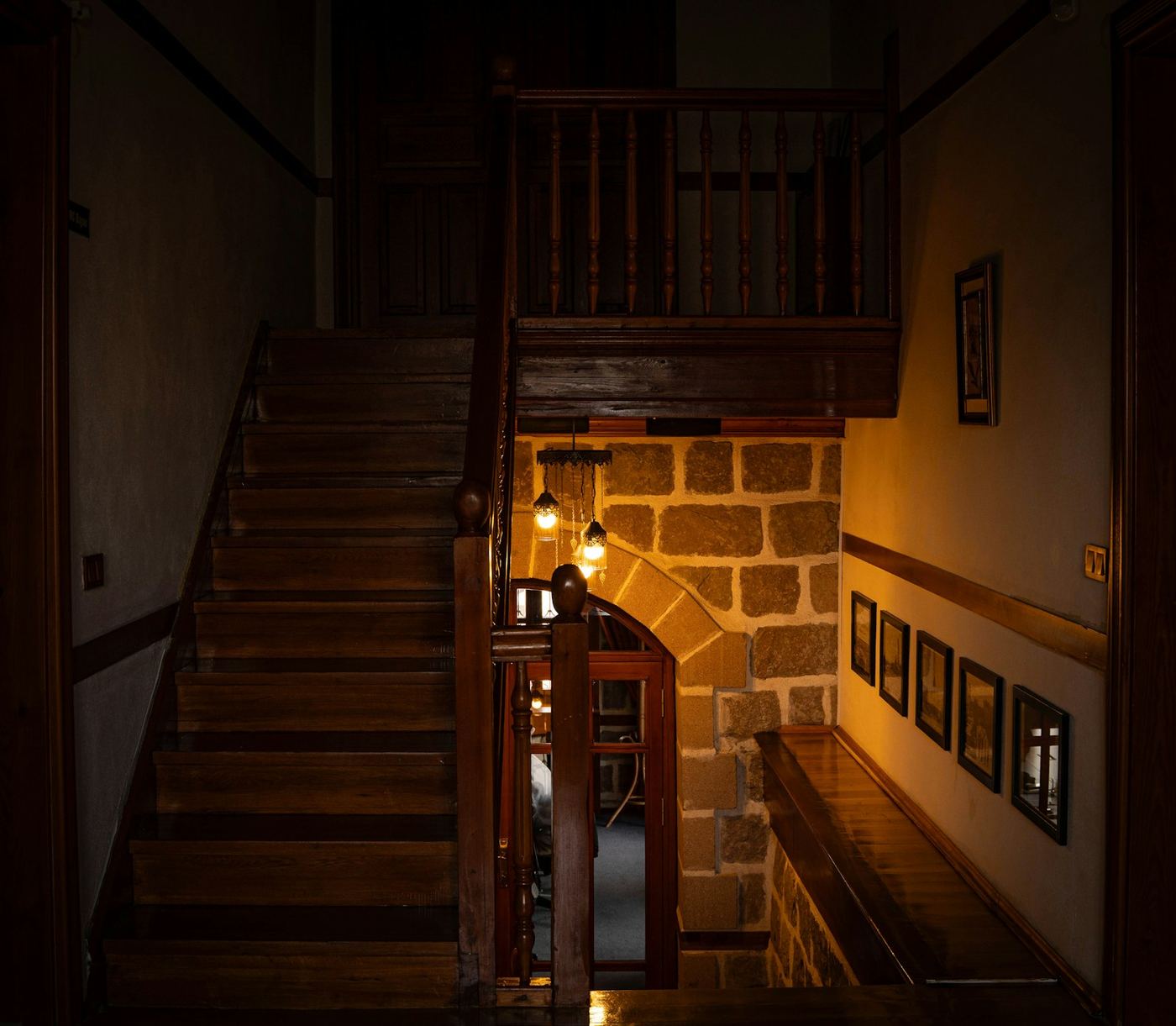 Wooden staircase with a stone wall