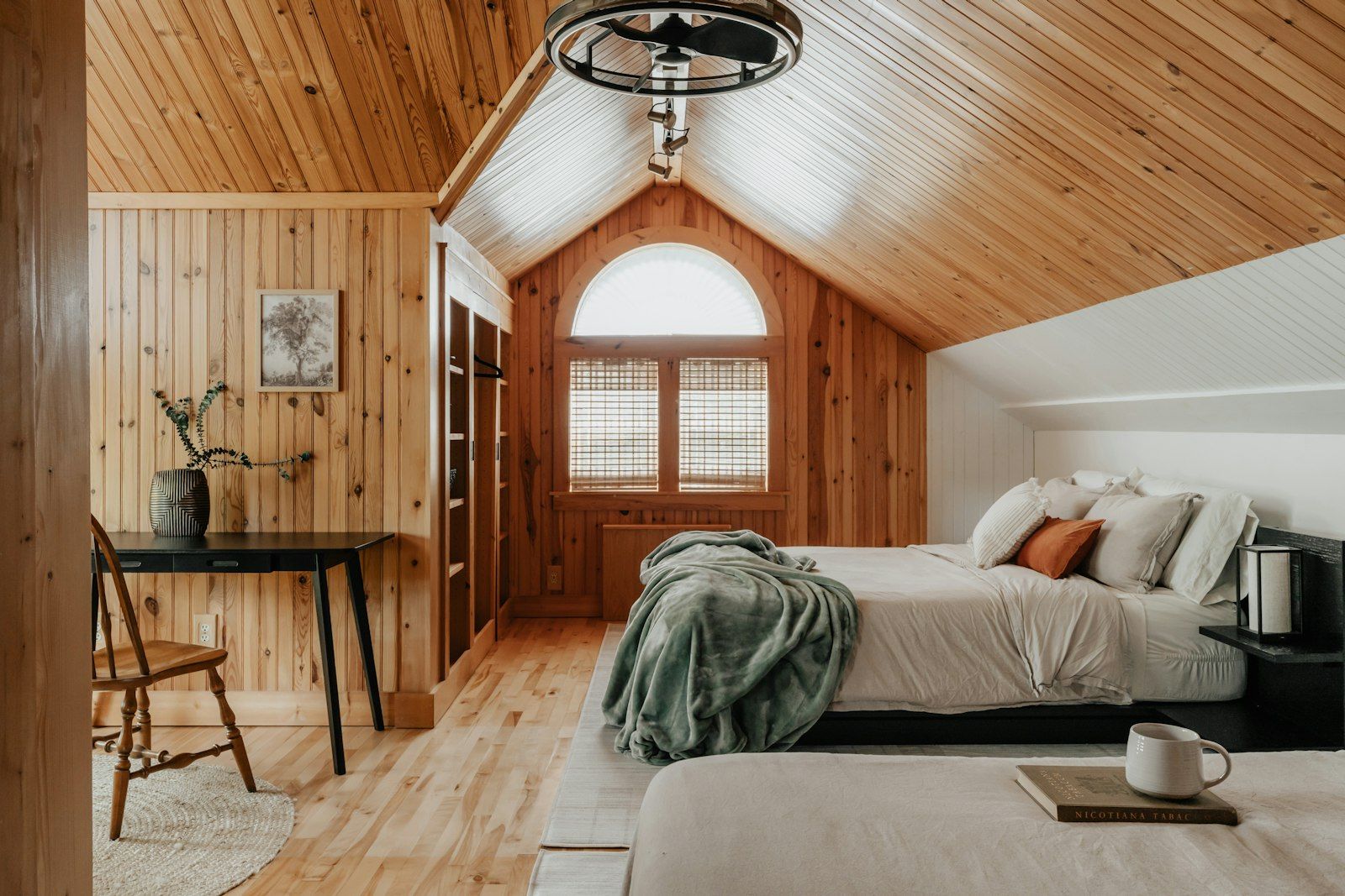 Bedroom with two beds and a desk