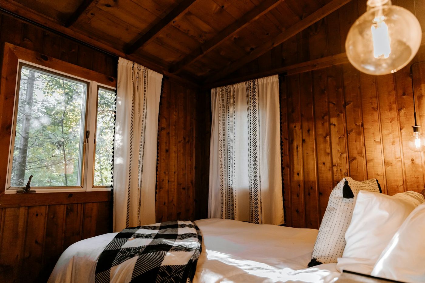Bed in a room with wooden walls
