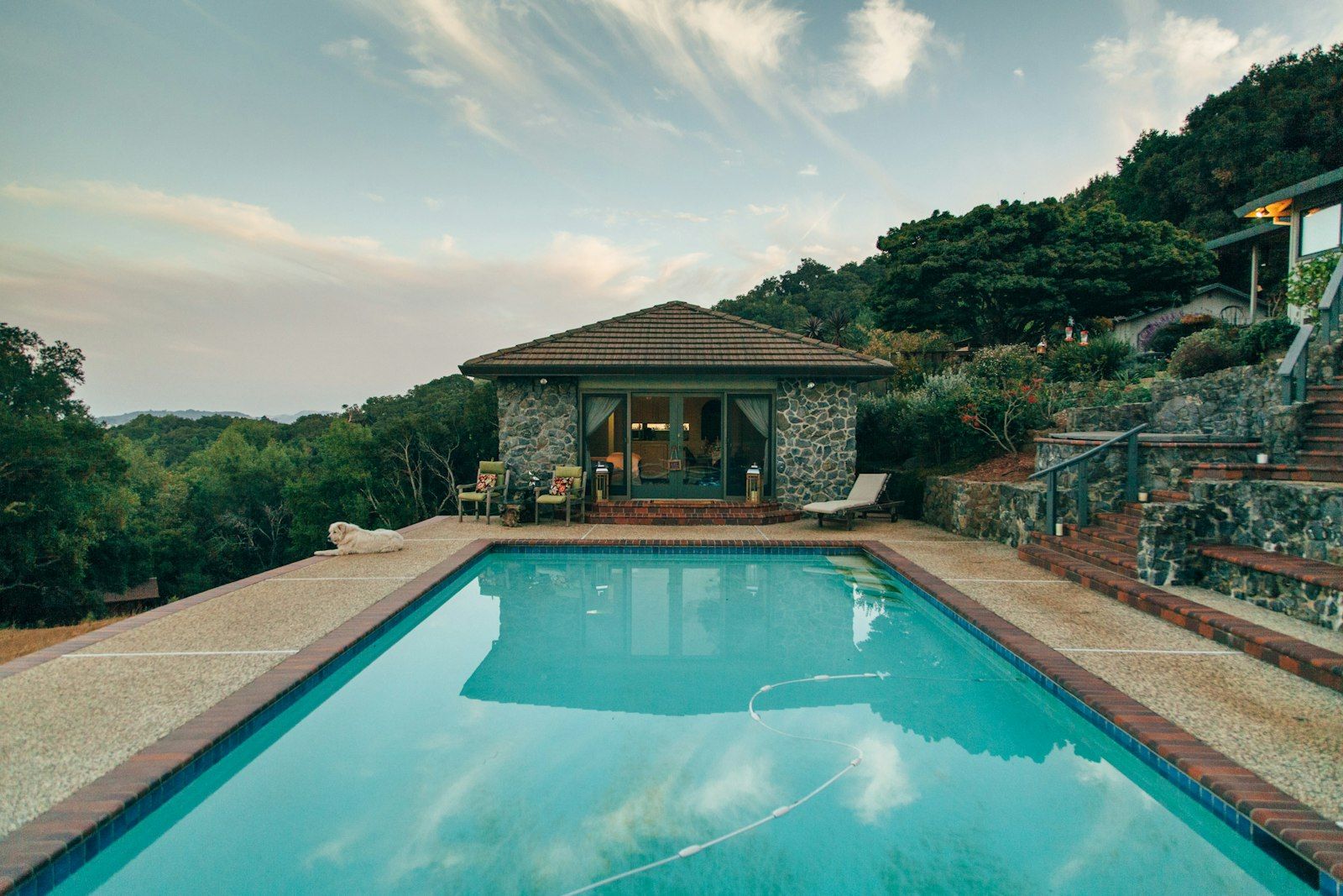 Stone pool house with a swimming pool