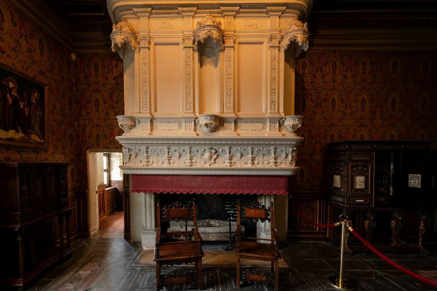 Ornate fireplace with chairs