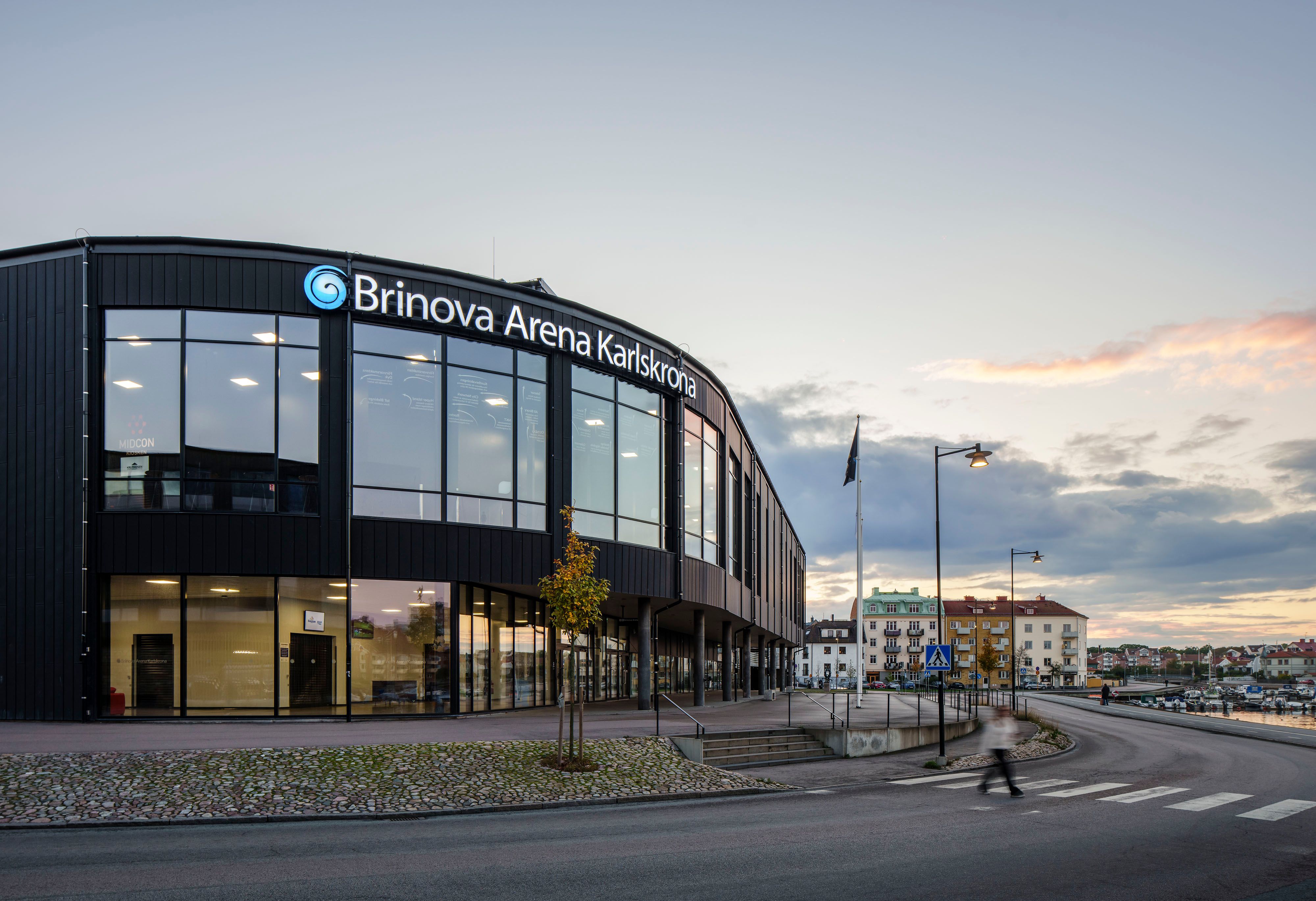 Brinova Arena Karlskrona, exteriör. Rundad fasad mot vattnet.