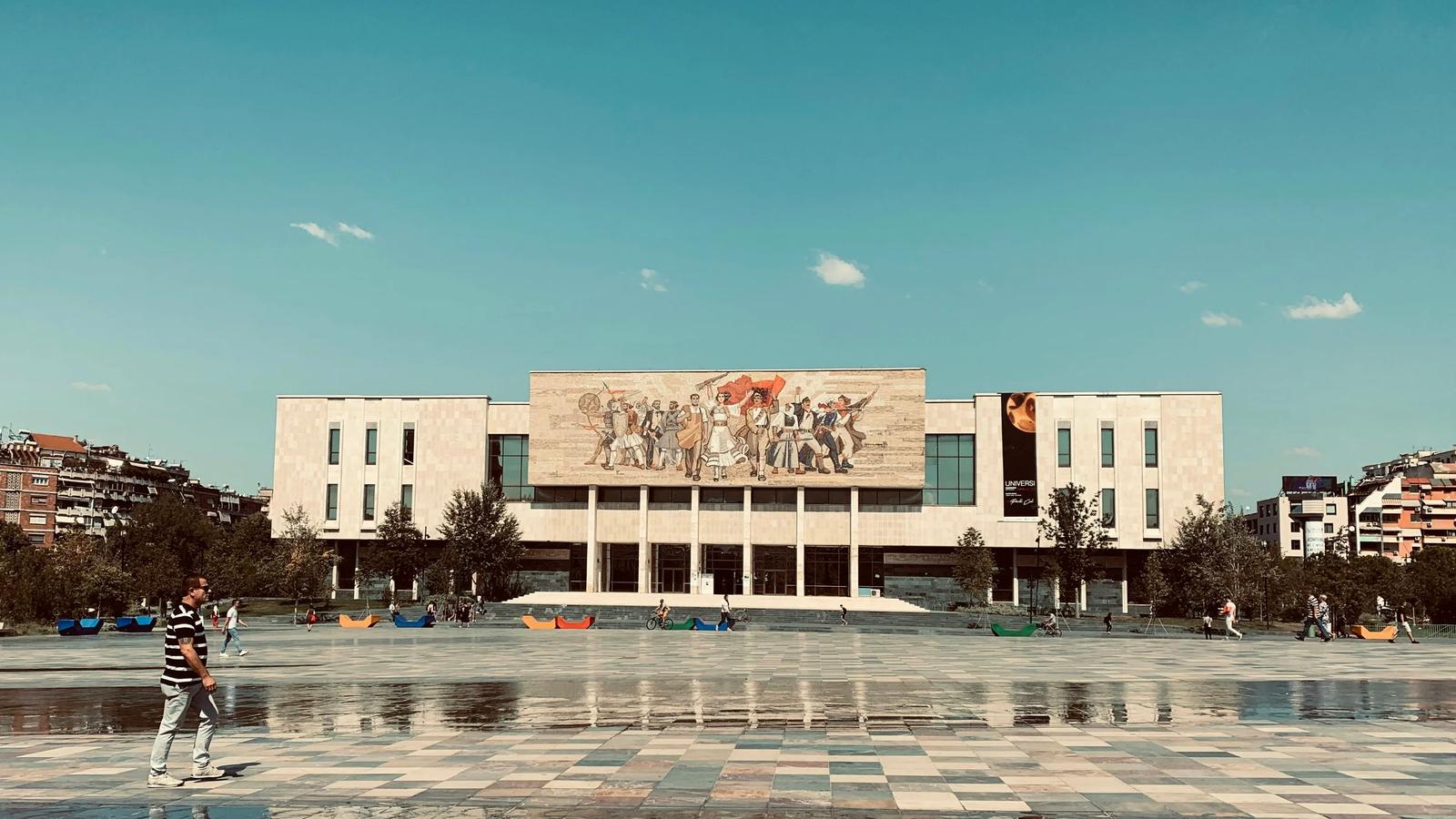 a person standing in front of a large building