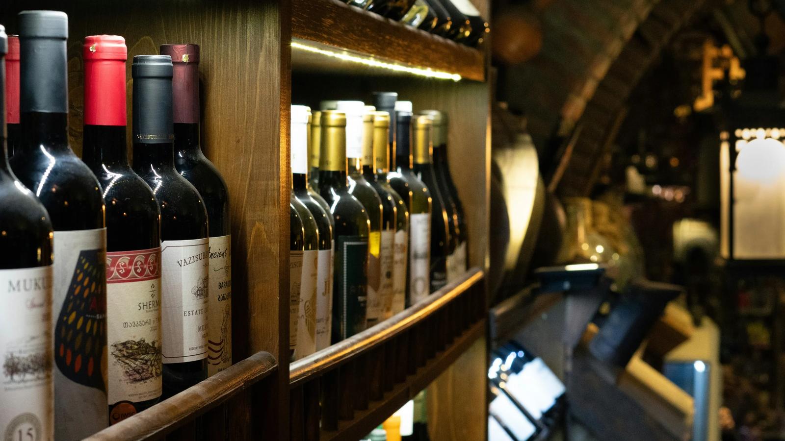 a bunch of bottles of wine on a shelf