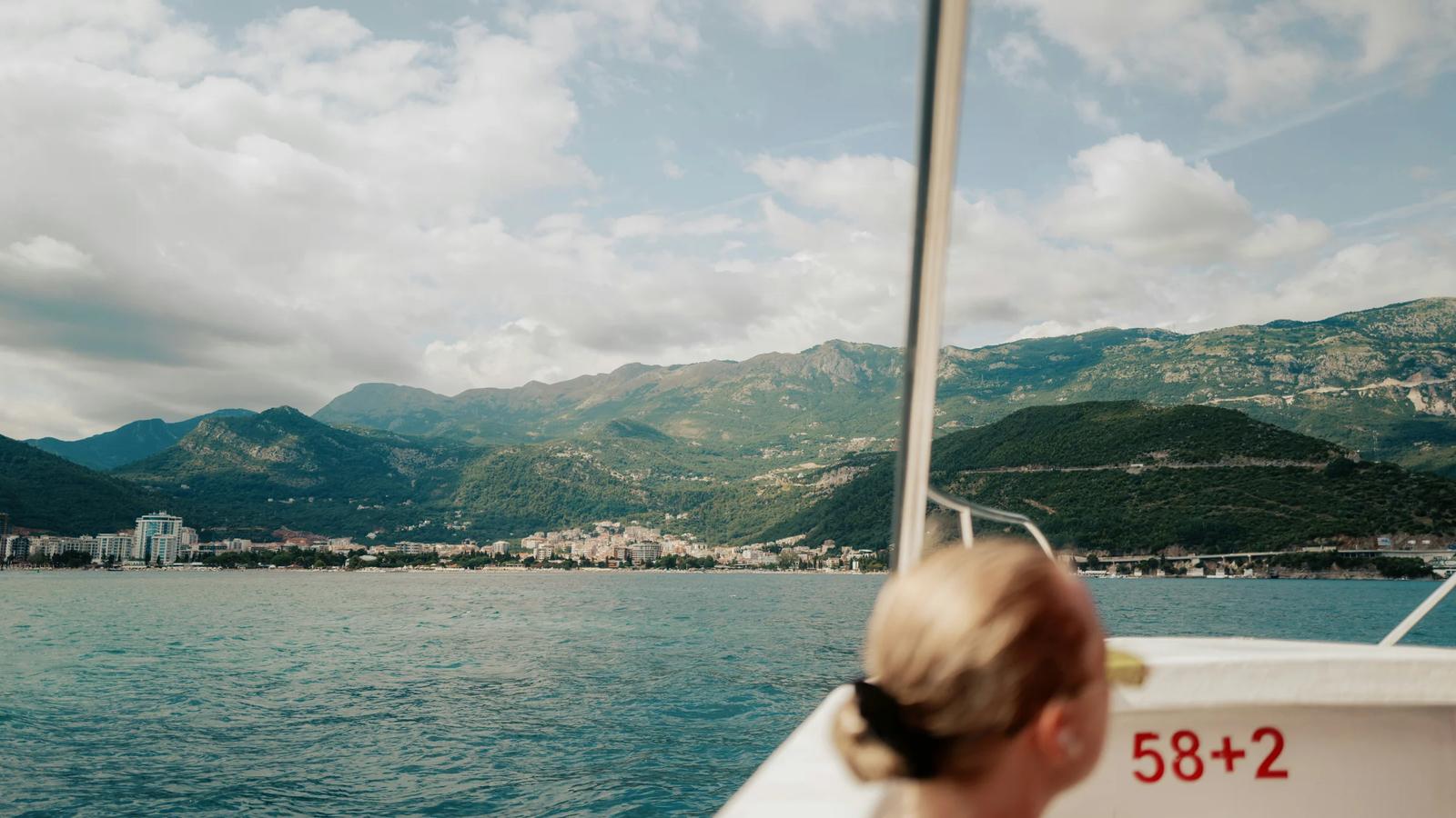 A woman sitting on a boat in the water