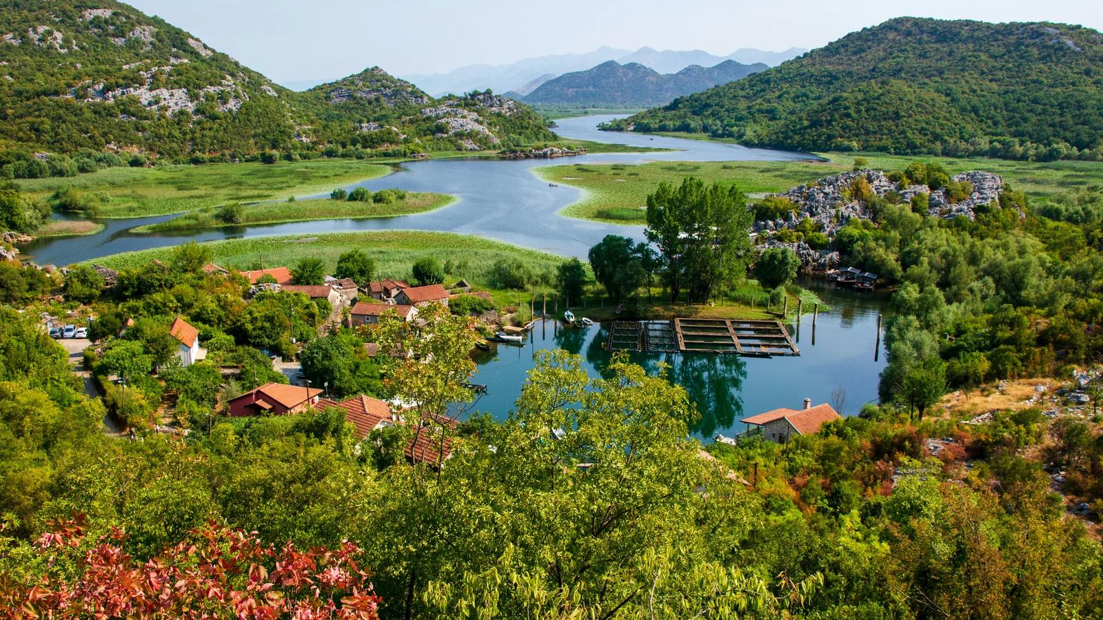 a river running through a lush green countryside