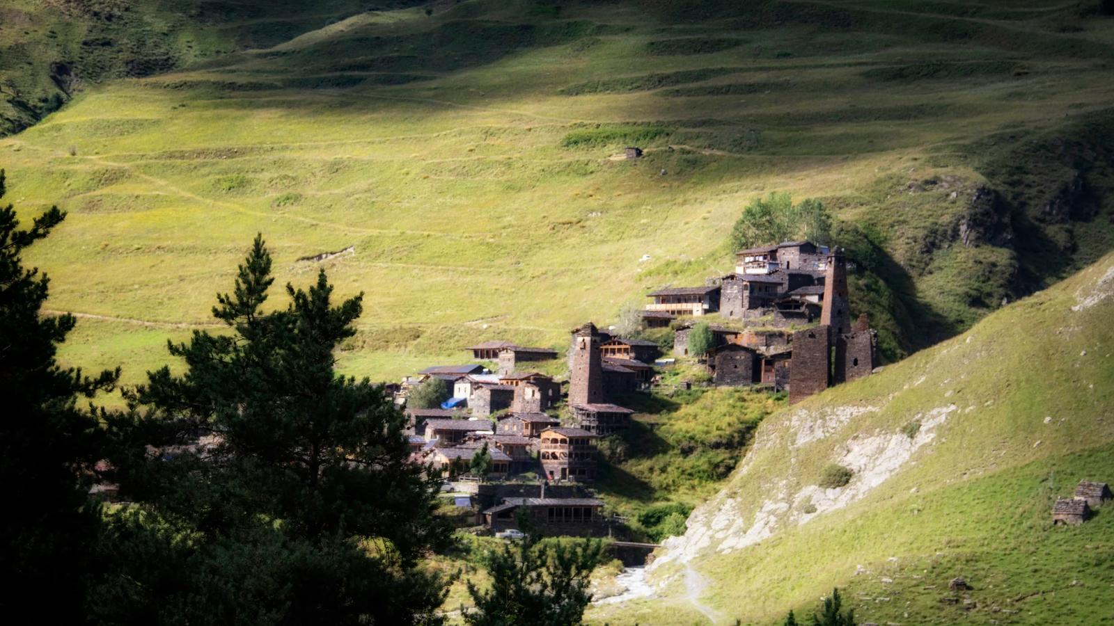 A view of a village in the middle of a valley