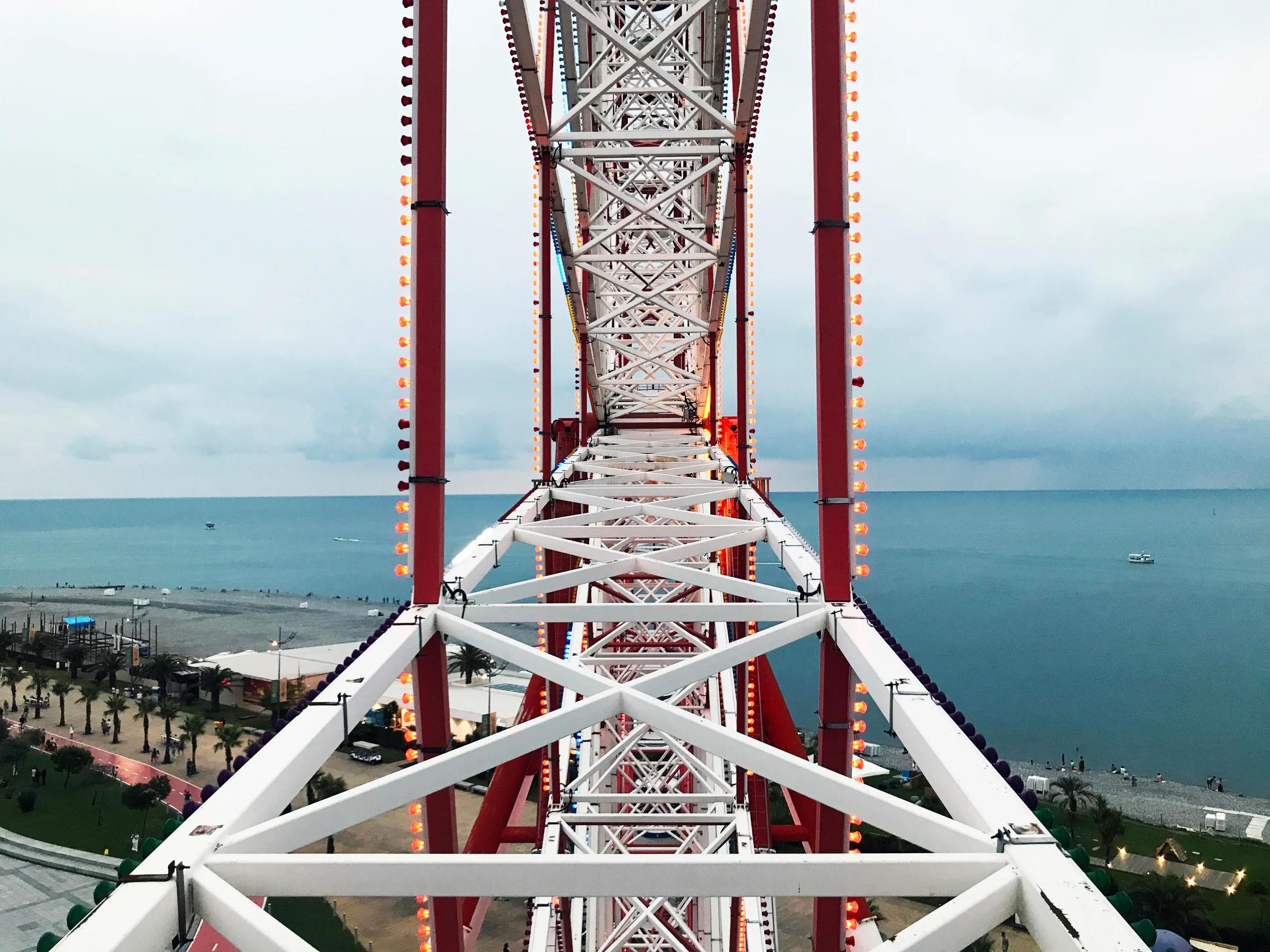 brown and white metal bridge over blue sea during daytime