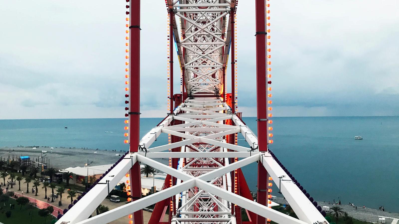 brown and white metal bridge over blue sea during daytime