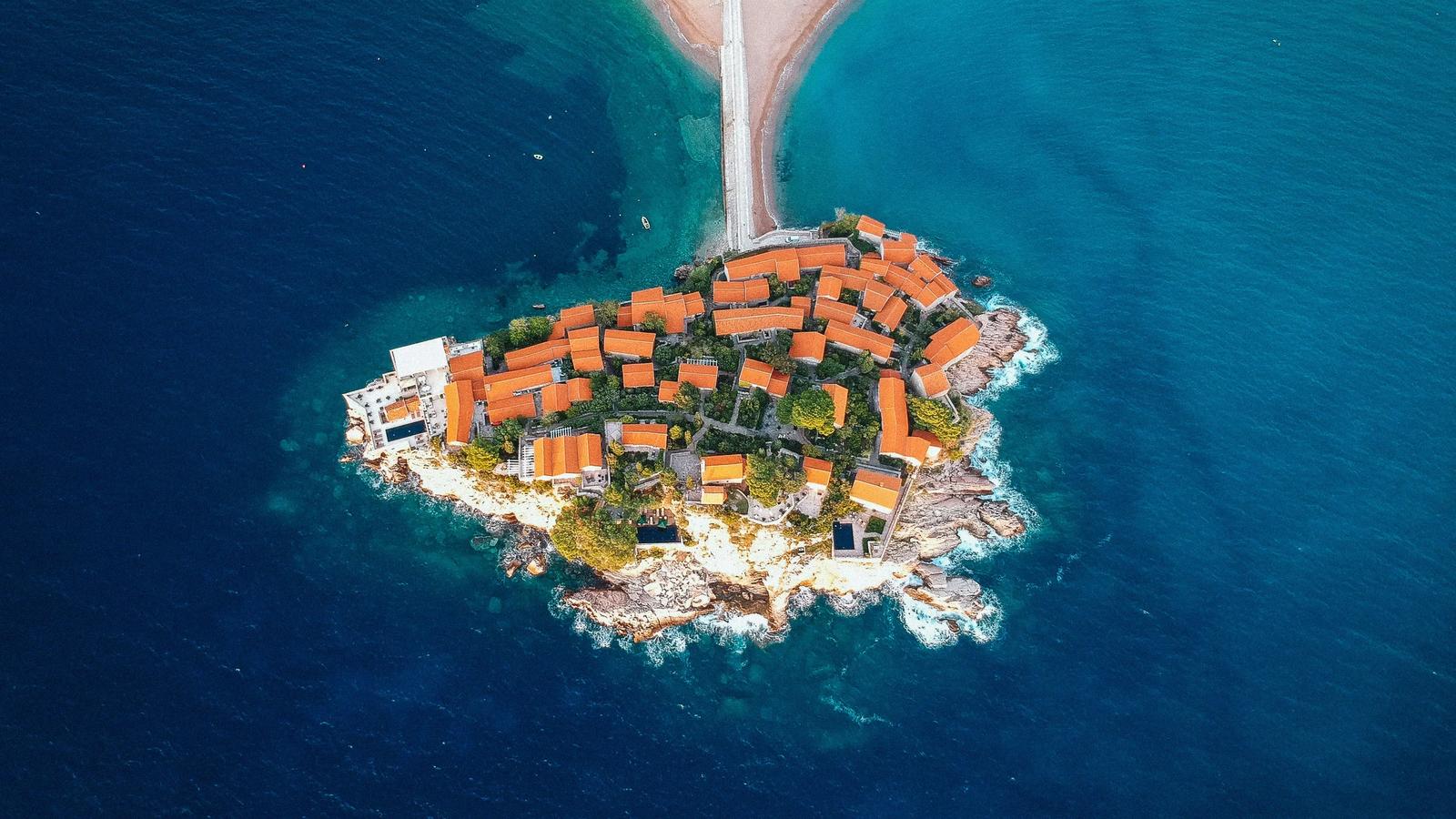aerial view of city buildings near body of water during daytime