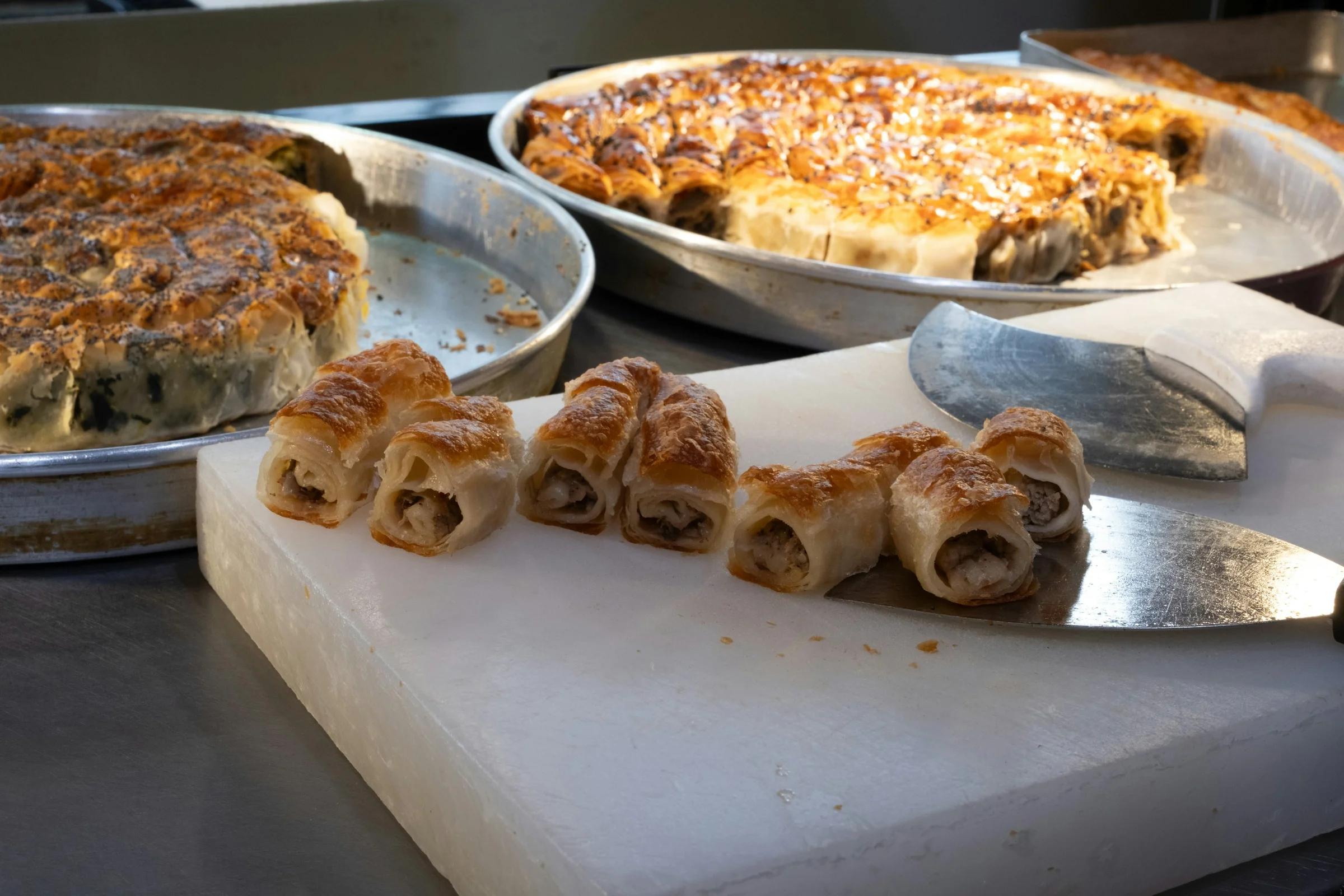 Baked pastries on a white cutting board.