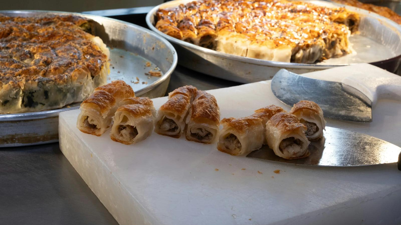 Baked pastries on a white cutting board.