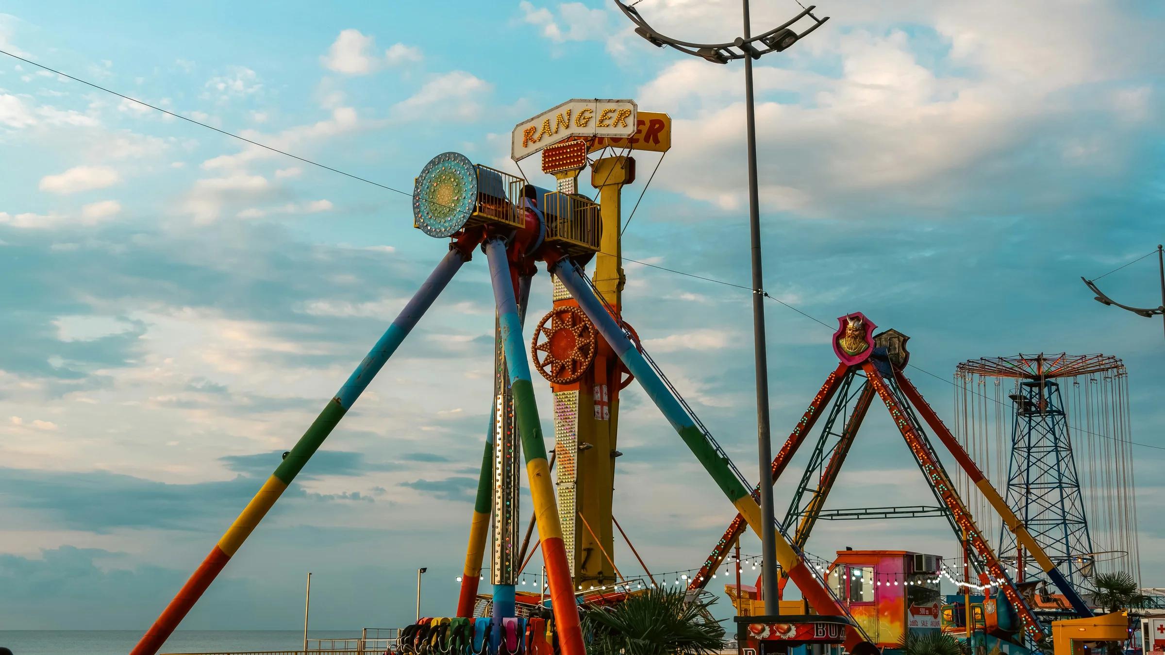 An amusement park with a ferris wheel and rides