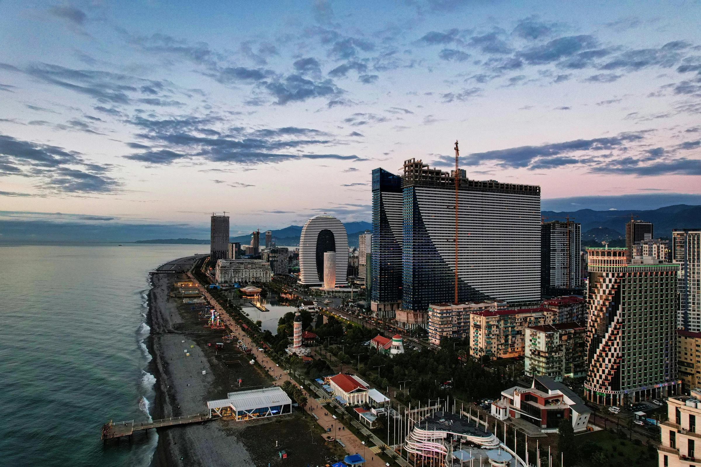 city skyline under cloudy sky during daytime