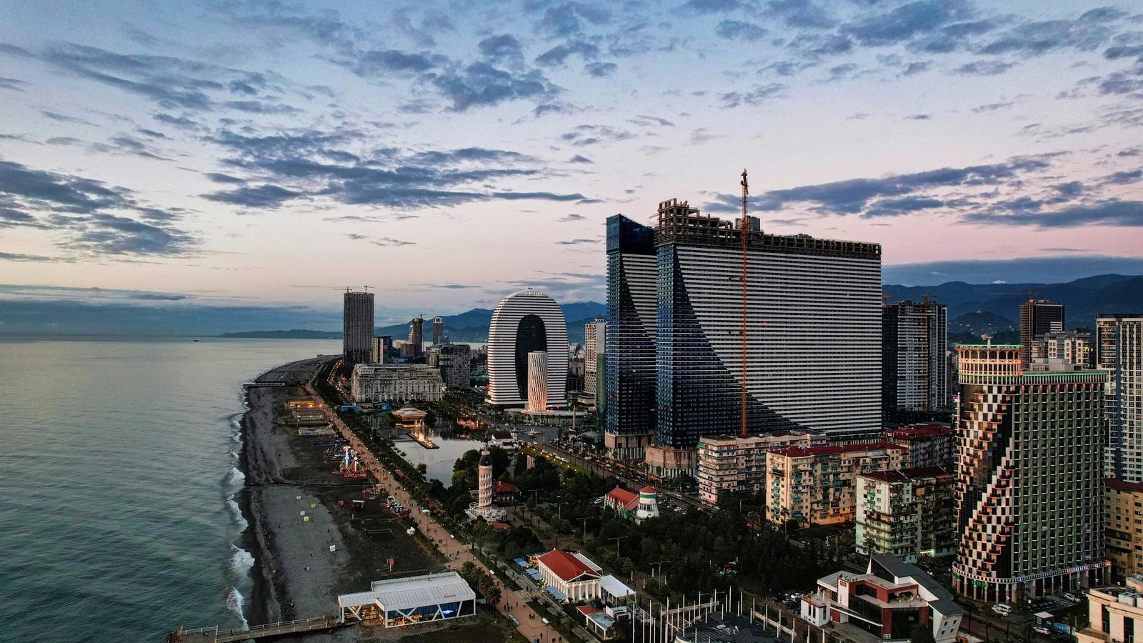 city skyline under cloudy sky during daytime