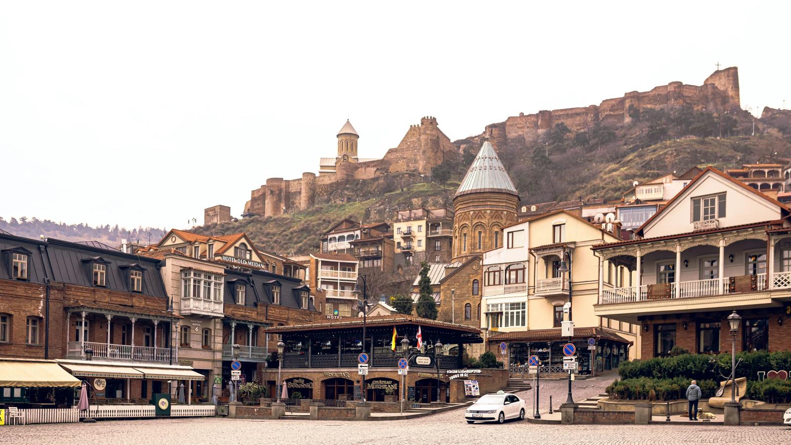 A group of buildings with a mountain in the background