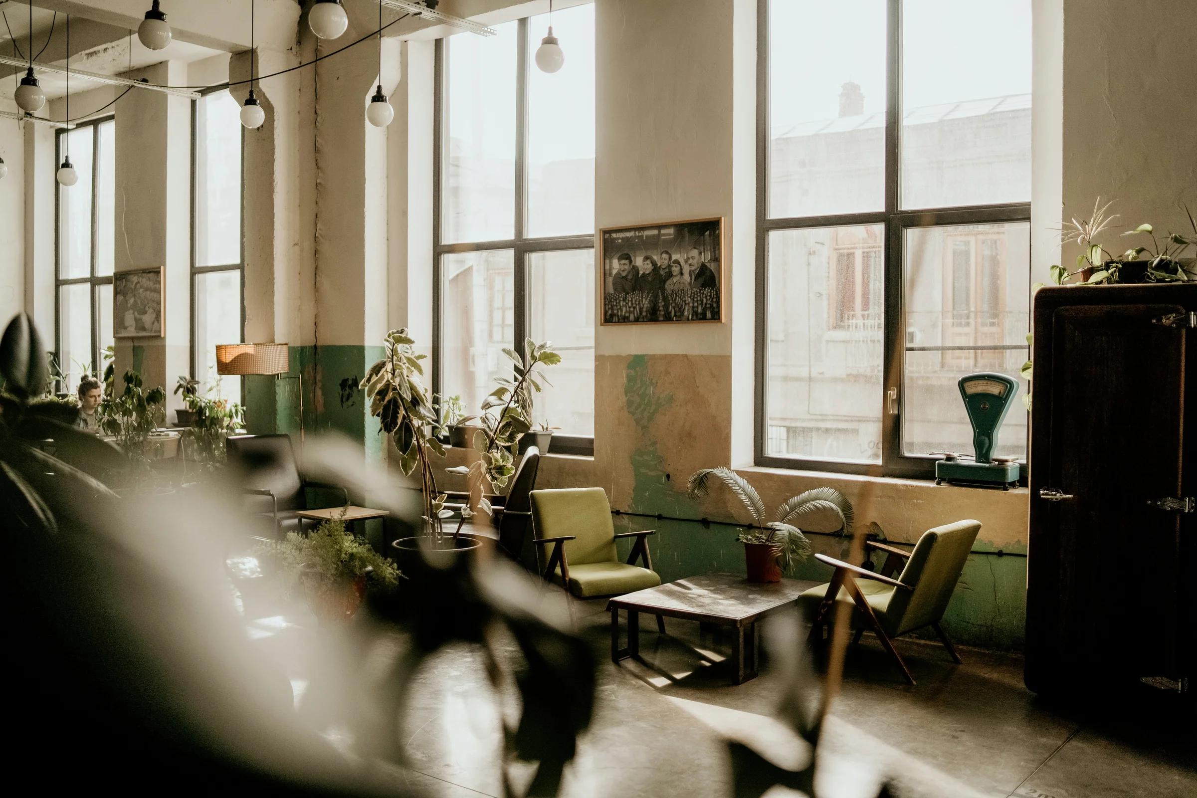 a room filled with lots of windows and furniture
