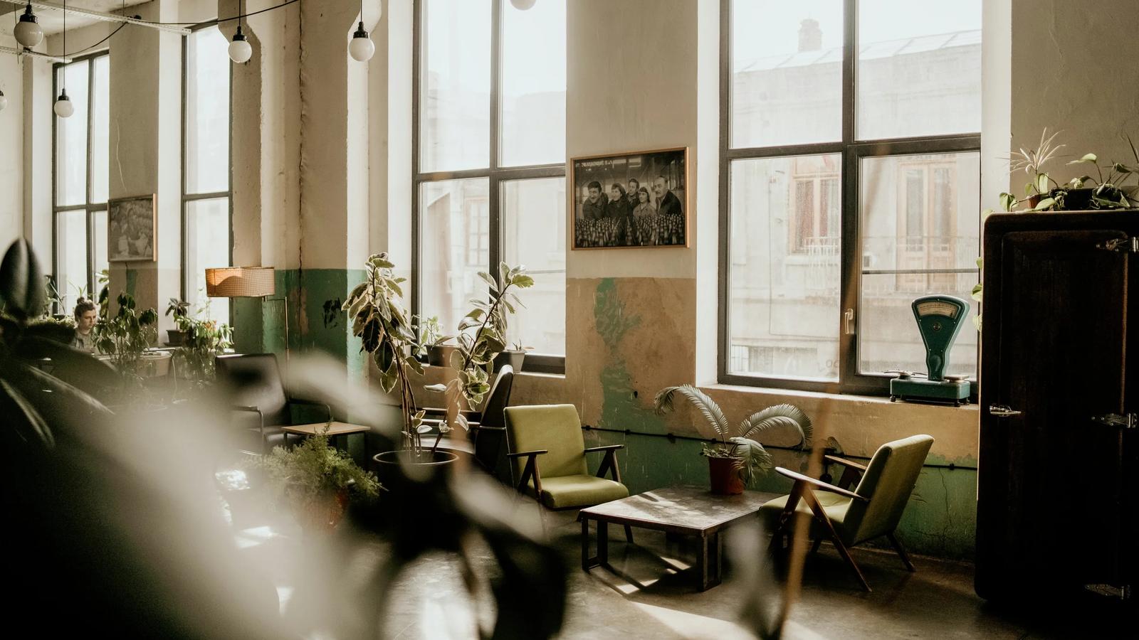 a room filled with lots of windows and furniture