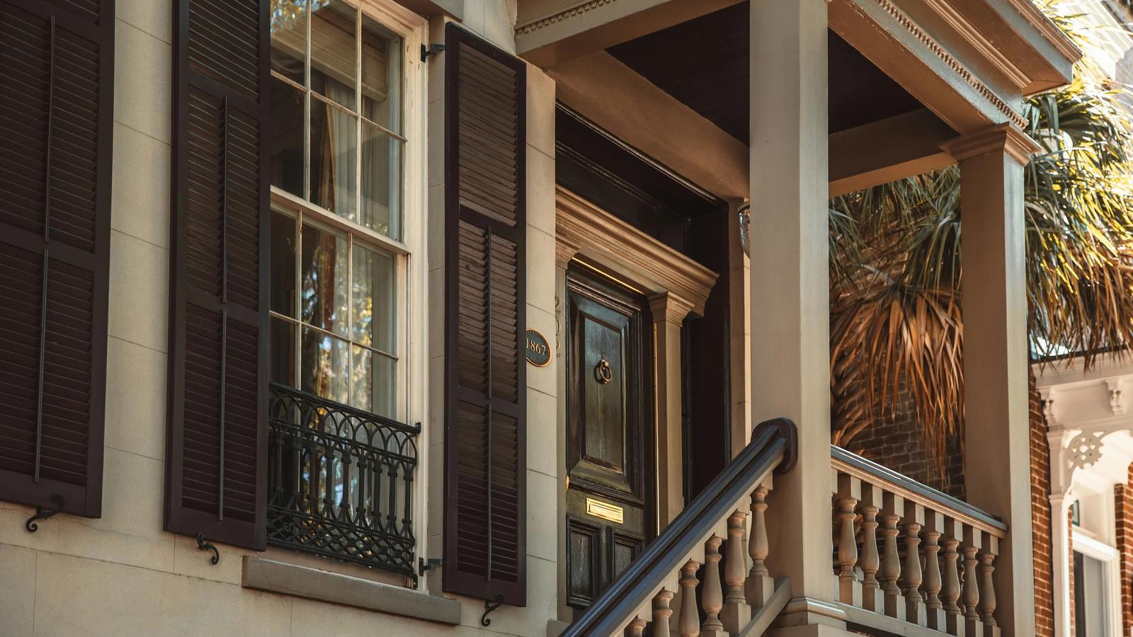 a building with a staircase and palm trees
