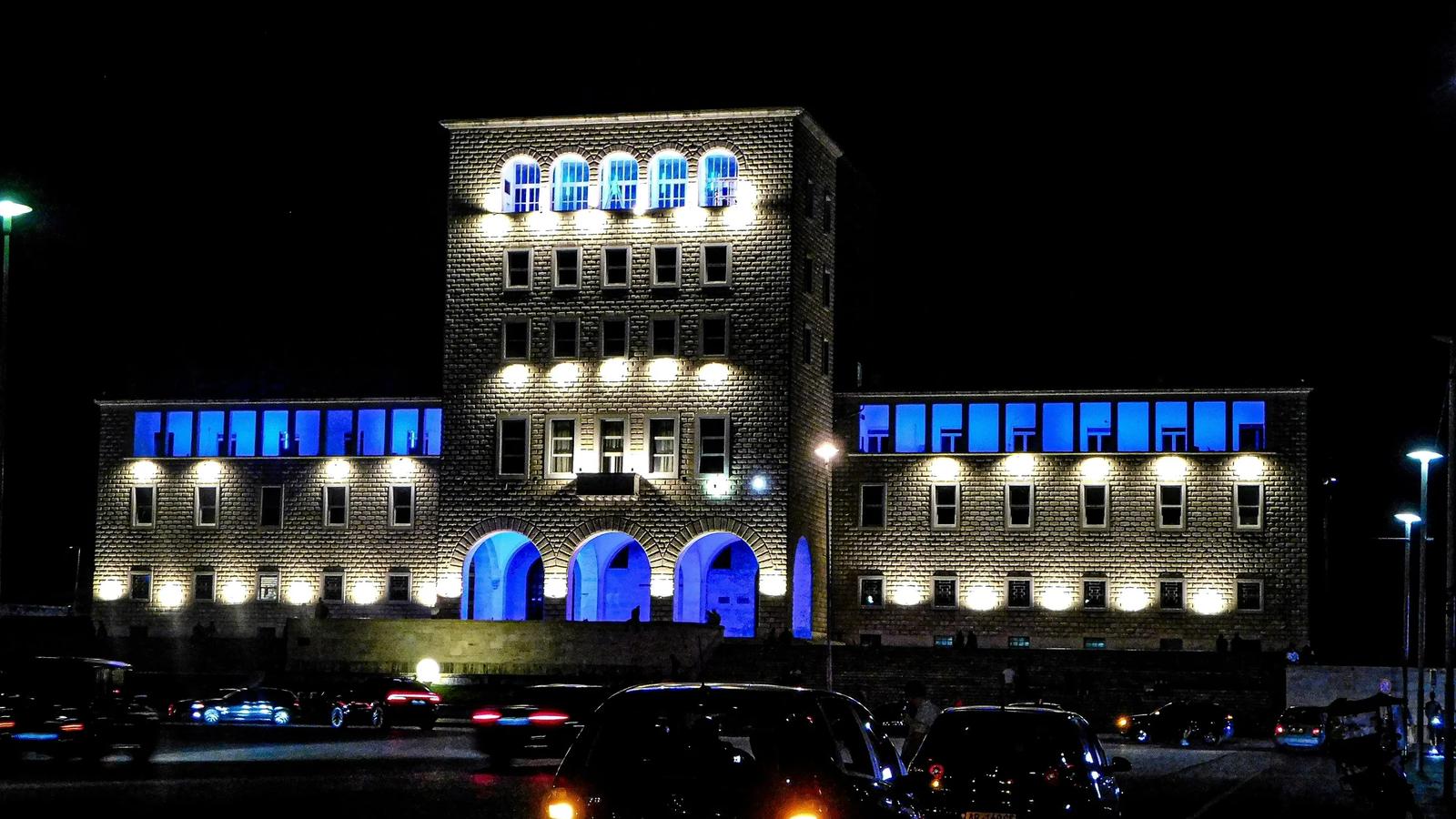 a building lit up with blue lights at night