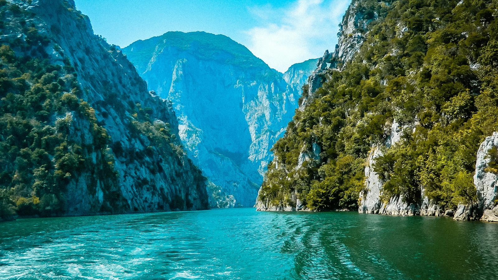 a body of water surrounded by mountains and trees