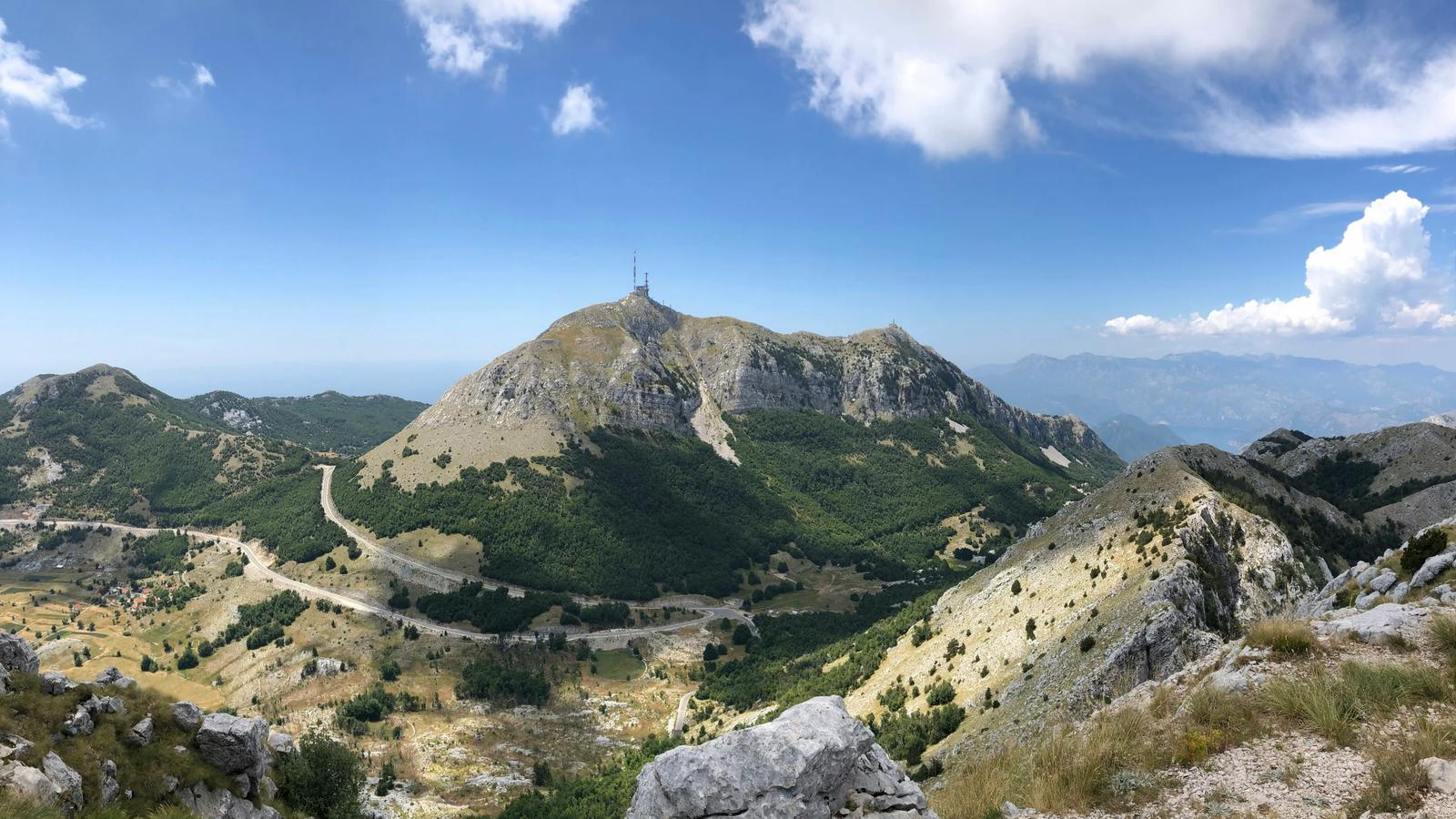 a rocky mountain with a tower