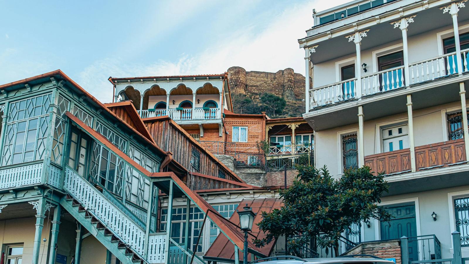 a van parked in front of a building with balconies