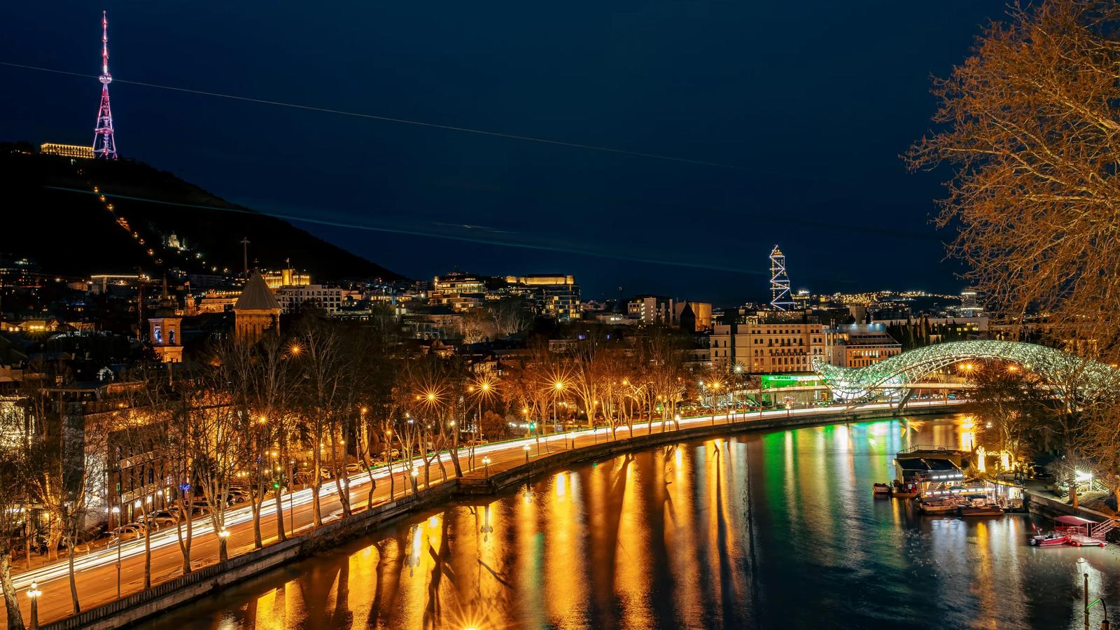 a night view of a city with a river running through it