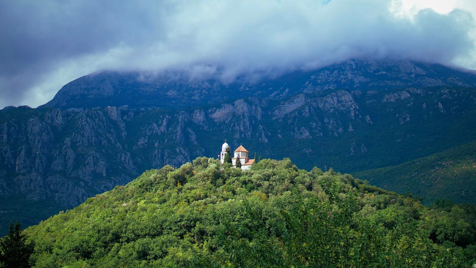 person sitting on top of mountain during daytime