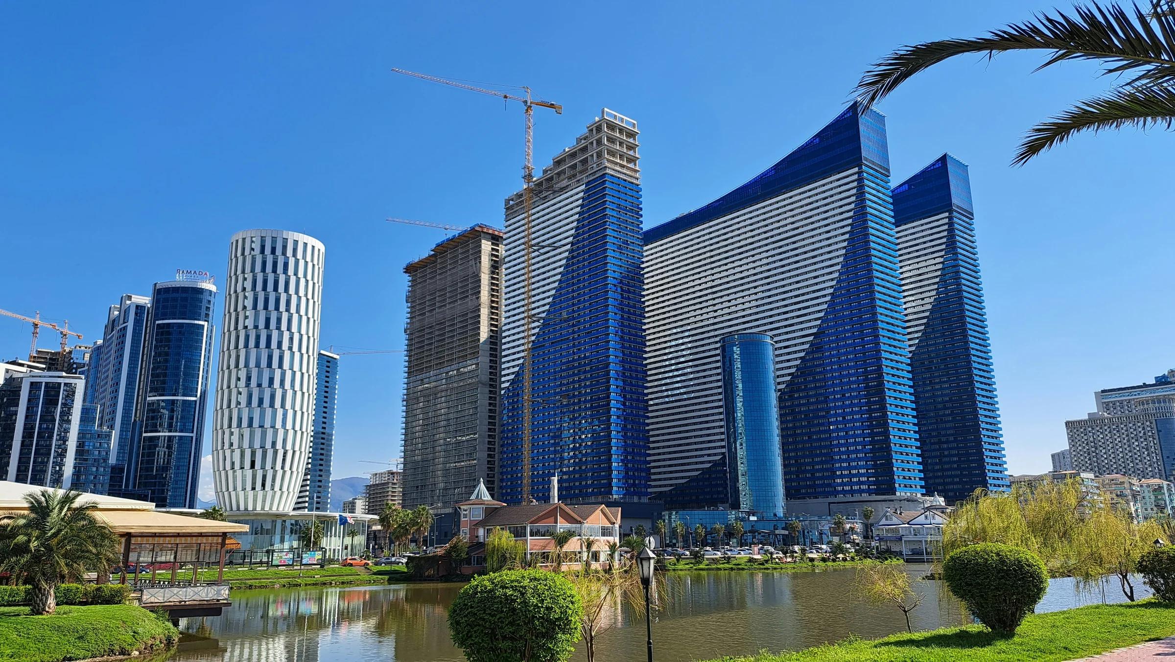 a city with tall buildings next to a body of water