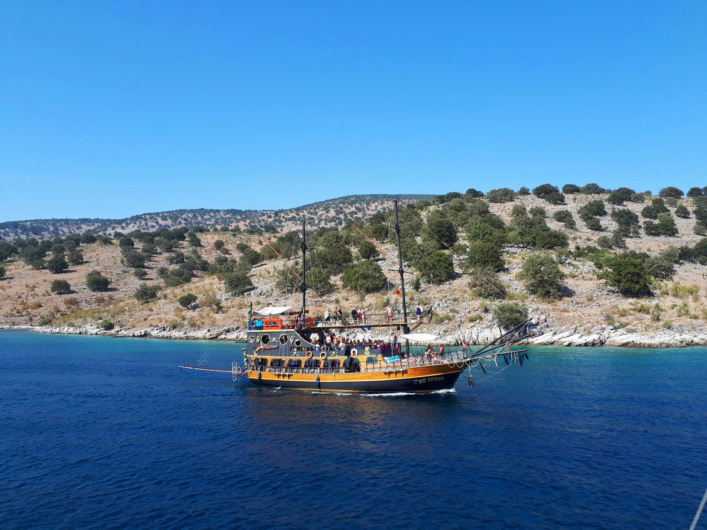 brown and white boat on sea during daytime