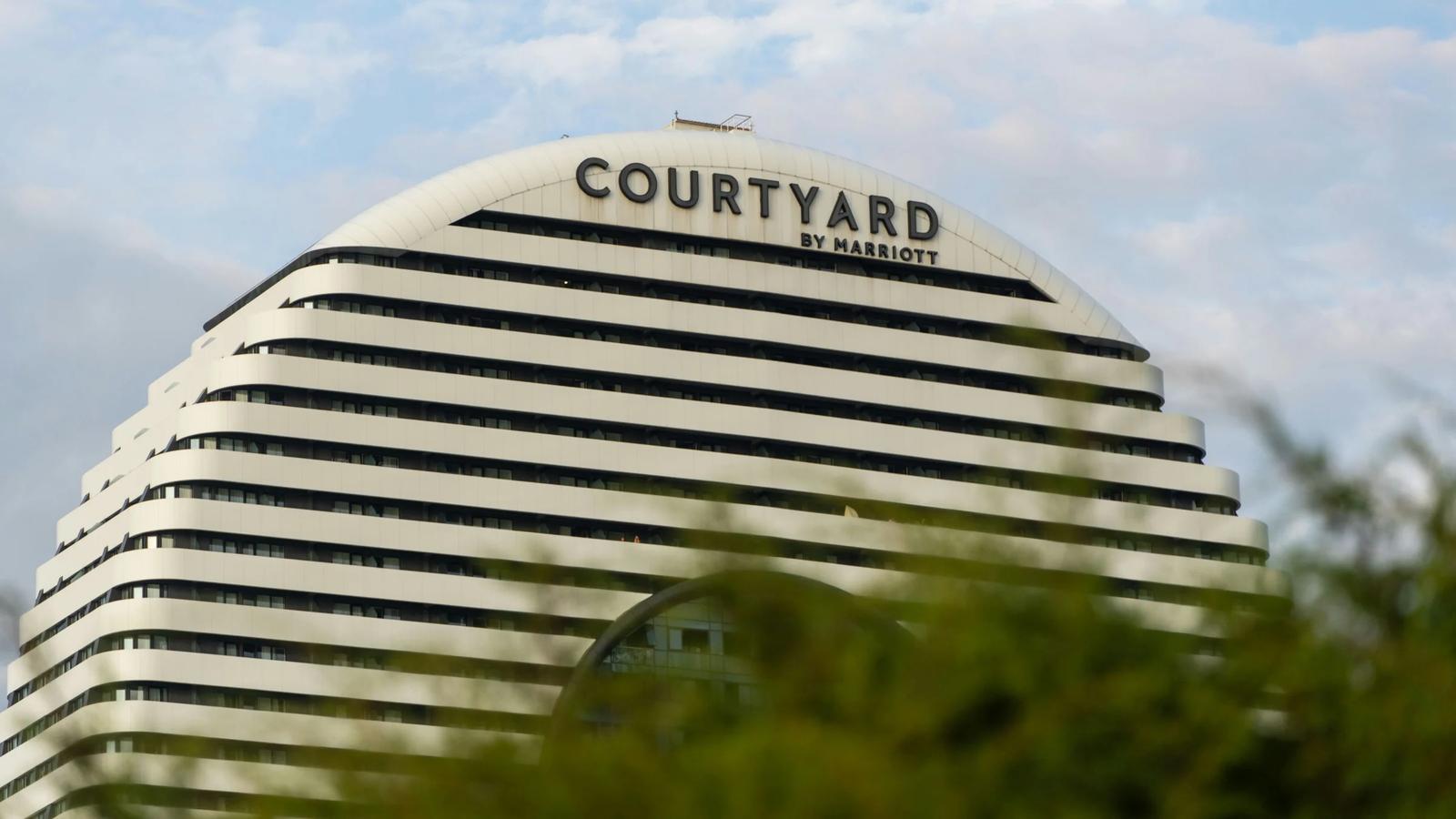 A building with a court yard sign on top of it