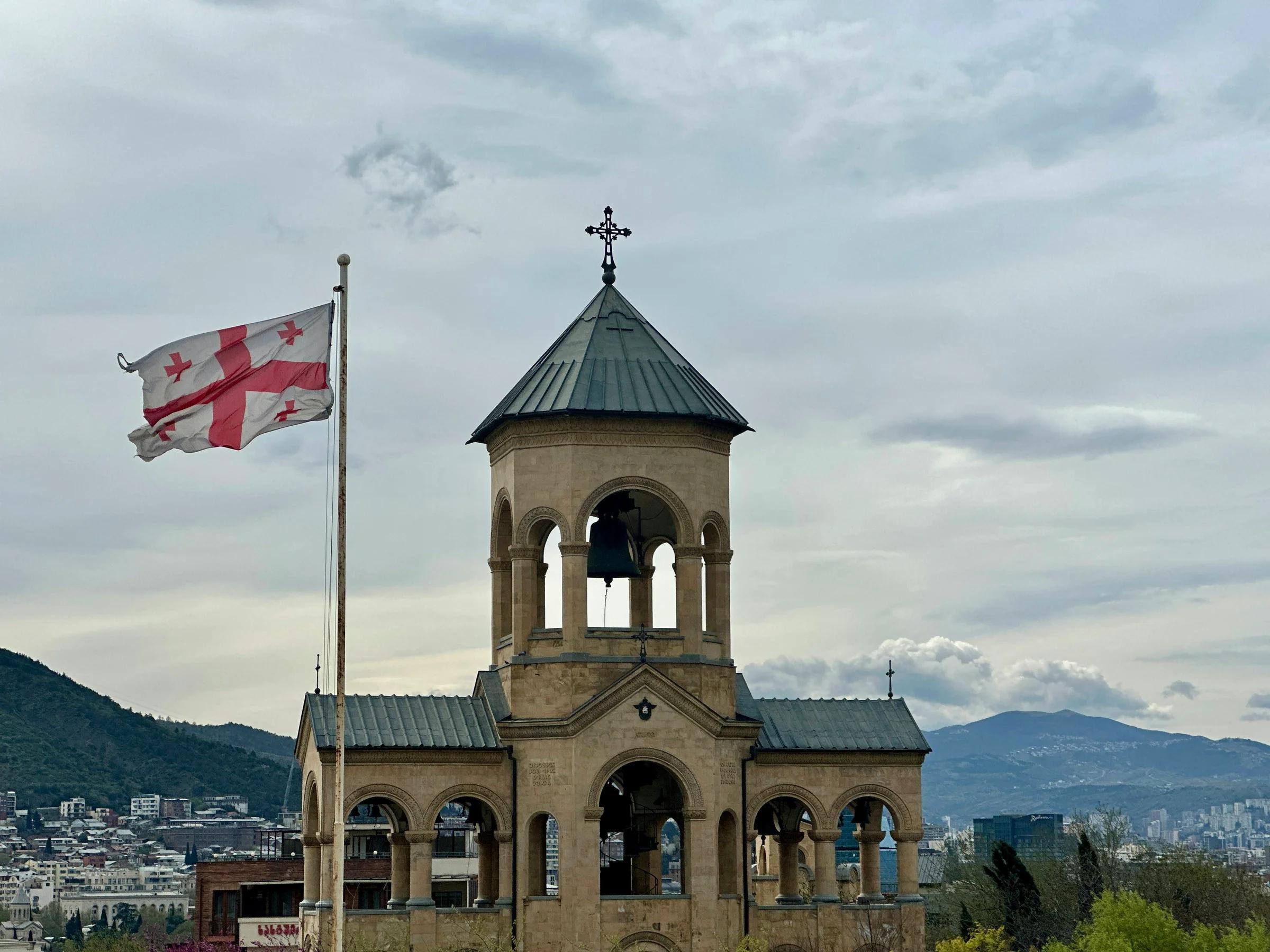an old building with a flag flying in front of it