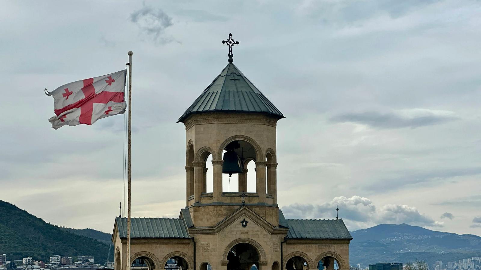 an old building with a flag flying in front of it