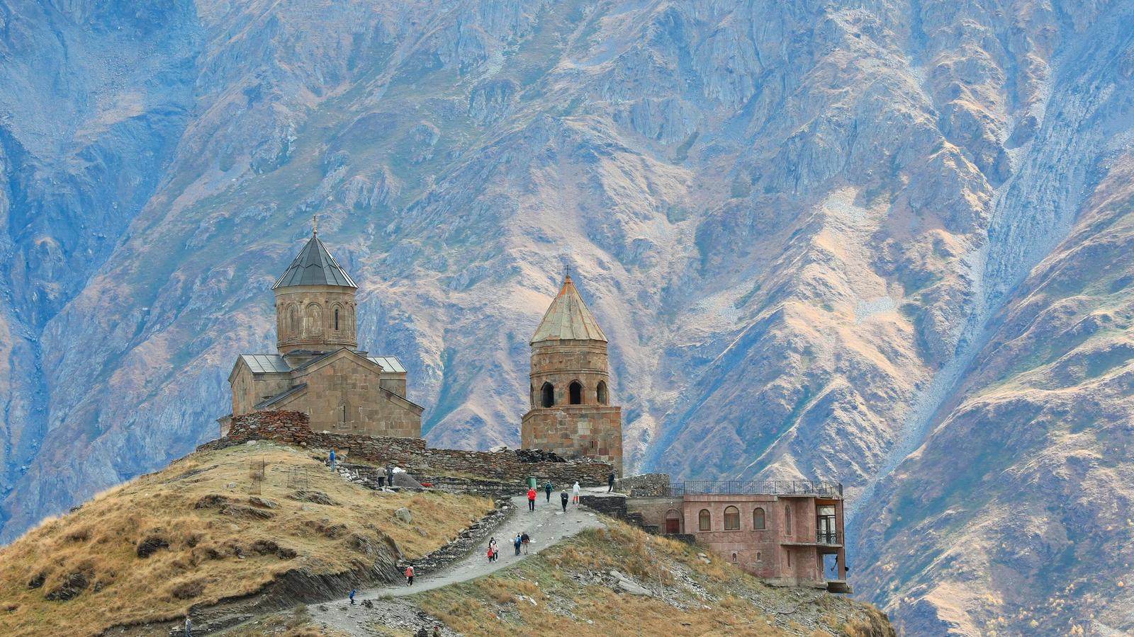 brown castle near rock formation during daytime