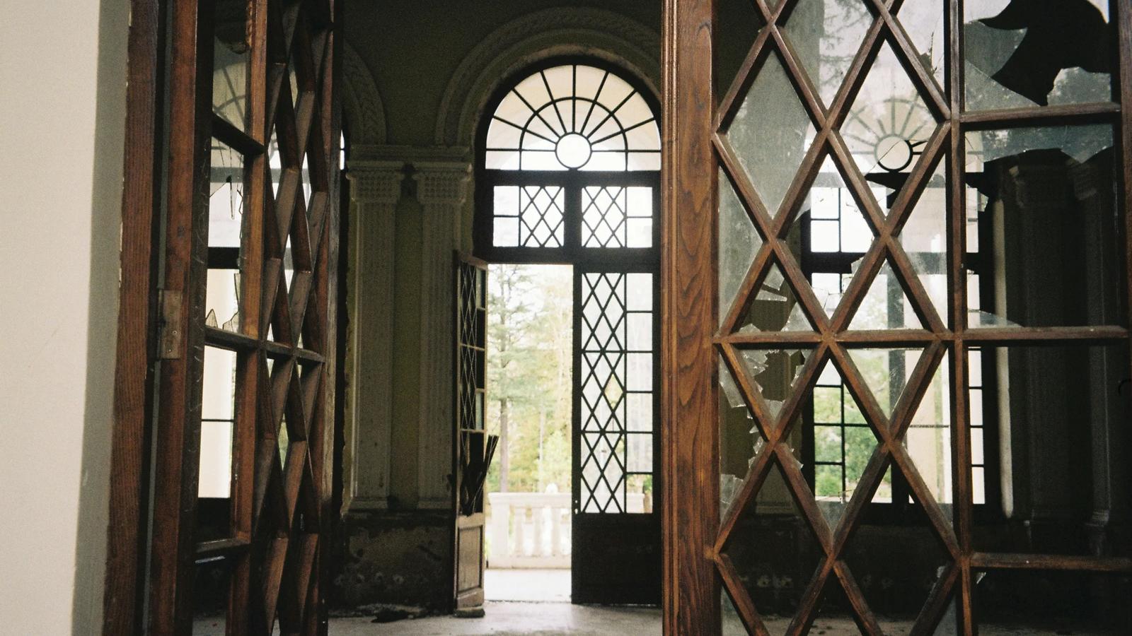 An open door leading into a room with a chandelier