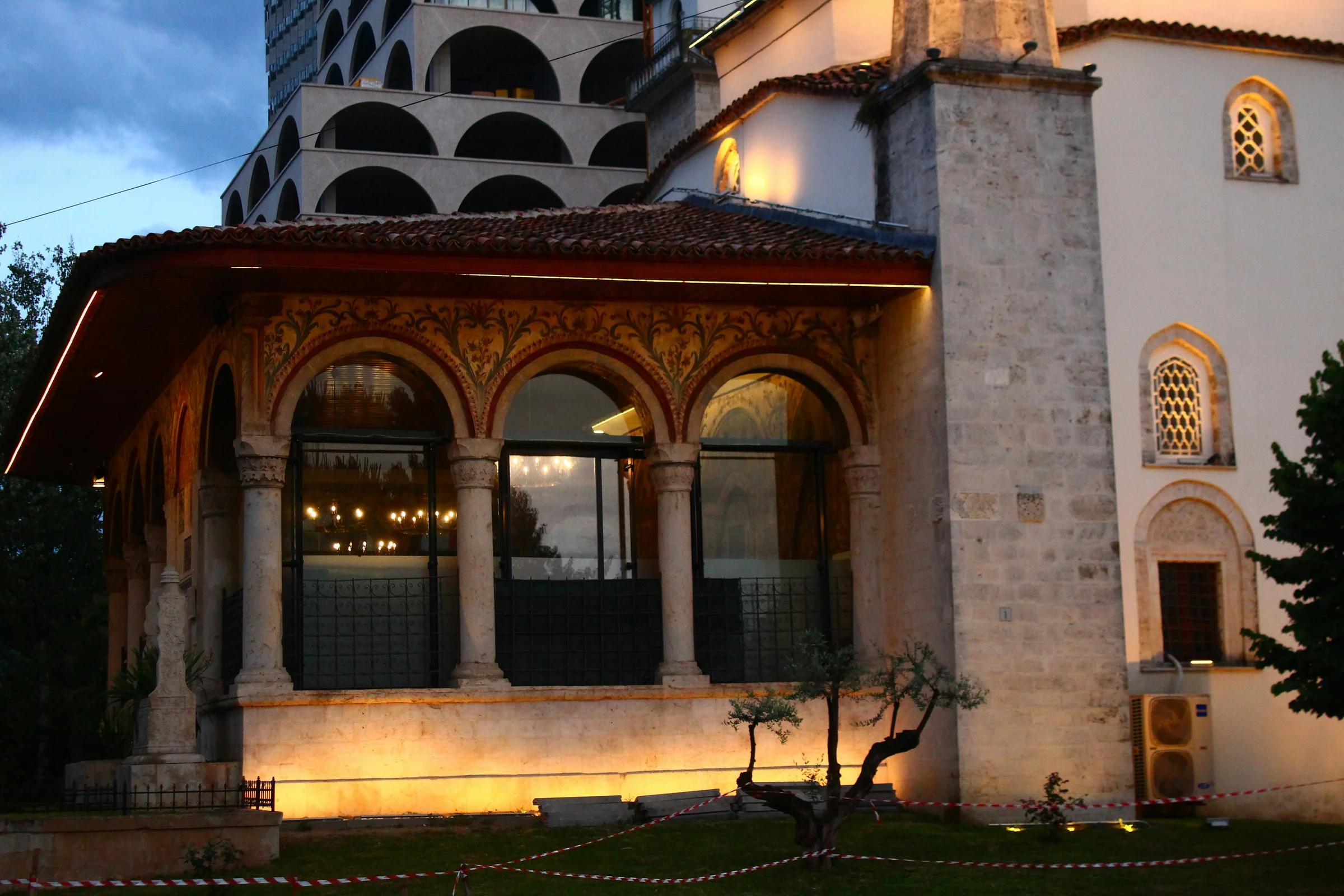 a tall building with a clock tower next to it